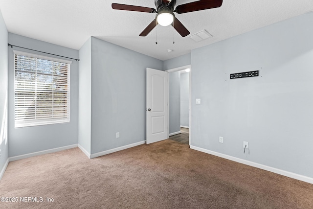 unfurnished bedroom with carpet flooring, baseboards, and visible vents