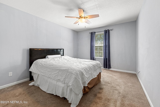 carpeted bedroom featuring a ceiling fan, baseboards, and a textured ceiling