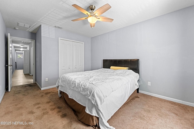 carpeted bedroom with baseboards, visible vents, and a closet