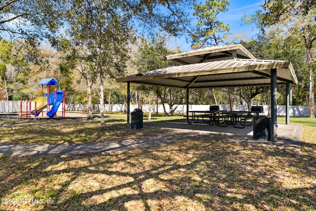 view of home's community with a gazebo, playground community, a yard, and fence