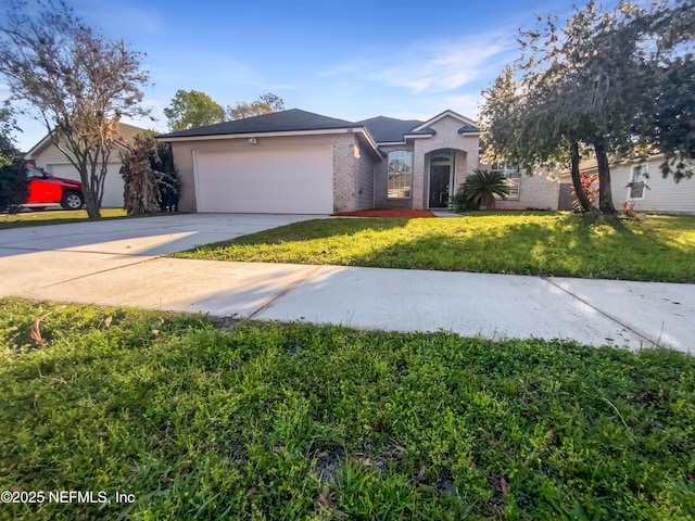 ranch-style home with a front yard, brick siding, an attached garage, and driveway