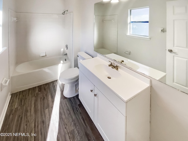 full bathroom featuring vanity, toilet, wood finished floors, and bathtub / shower combination