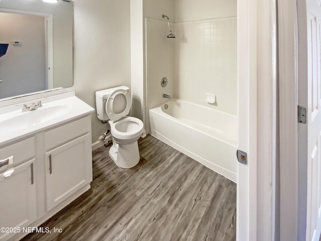 full bath with shower / bathtub combination, toilet, vanity, and wood finished floors