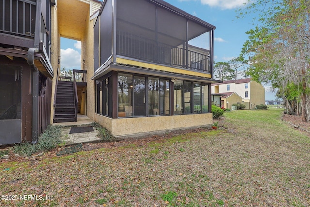 5400 La Moya Ave Unit 16, Jacksonville, FL 32210 - rear view of house with a lawn, stairs, and a sunroom