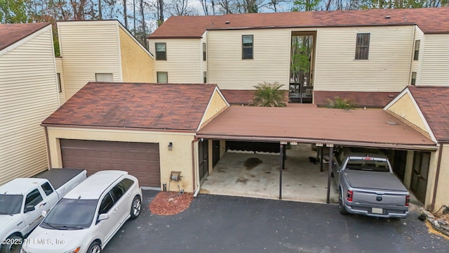 5400 La Moya Ave Unit 16, Jacksonville, FL 32210 - view of front facade with aphalt driveway, a garage, and stucco siding