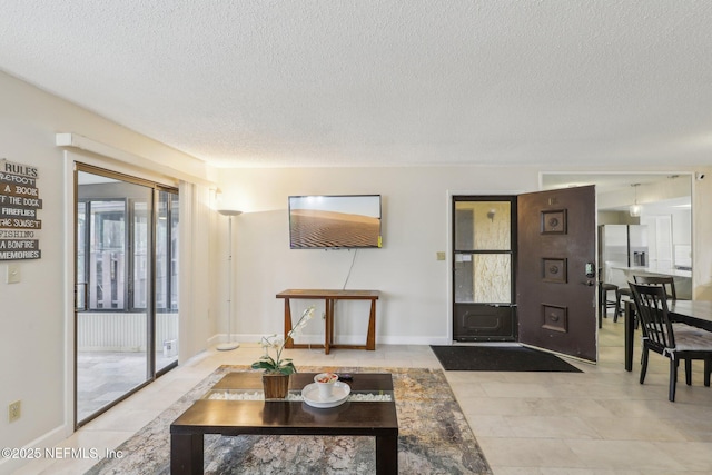 5400 La Moya Ave Unit 16, Jacksonville, FL 32210 - living area with baseboards, a textured ceiling, and tile patterned flooring