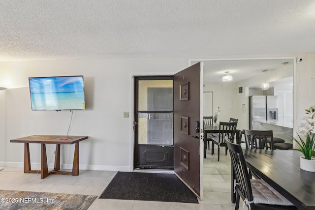 5400 La Moya Ave Unit 16, Jacksonville, FL 32210 - entryway with baseboards, a textured ceiling, and tile patterned flooring