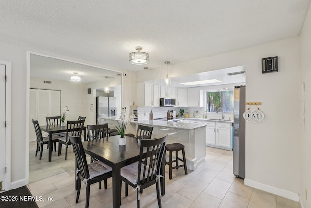 5400 La Moya Ave Unit 16, Jacksonville, FL 32210 - dining space with visible vents, a textured ceiling, and baseboards
