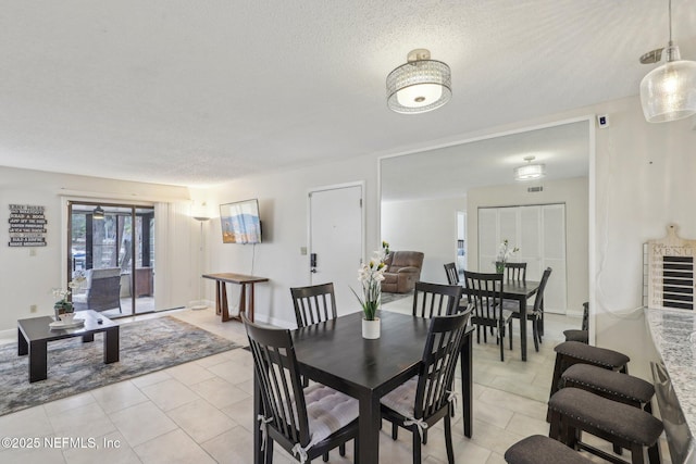 5400 La Moya Ave Unit 16, Jacksonville, FL 32210 - dining space with light tile patterned floors, baseboards, and a textured ceiling