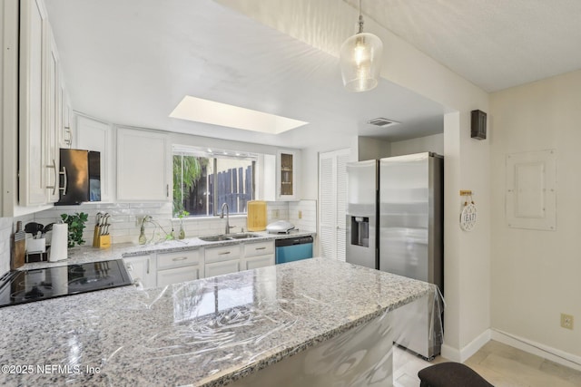 5400 La Moya Ave Unit 16, Jacksonville, FL 32210 - kitchen featuring light stone countertops, electric panel, decorative backsplash, appliances with stainless steel finishes, and a sink