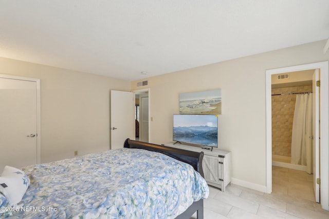 5400 La Moya Ave Unit 16, Jacksonville, FL 32210 - bedroom featuring light tile patterned flooring, baseboards, visible vents, and ensuite bathroom
