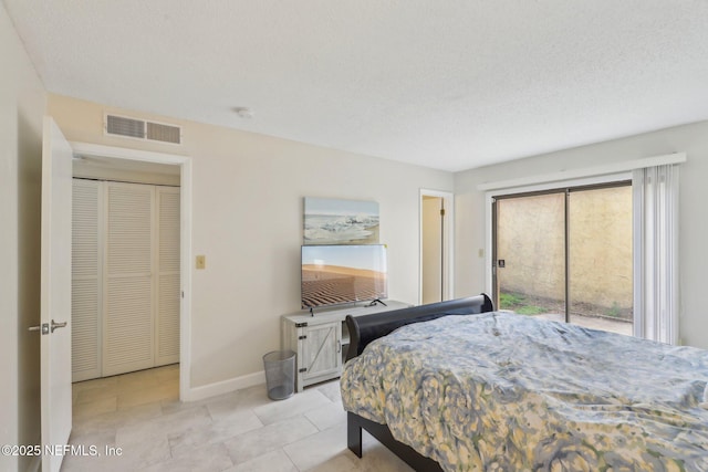 5400 La Moya Ave Unit 16, Jacksonville, FL 32210 - bedroom featuring baseboards, visible vents, tile patterned flooring, access to exterior, and a textured ceiling