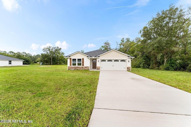 single story home featuring stone siding, a garage, driveway, and a front yard