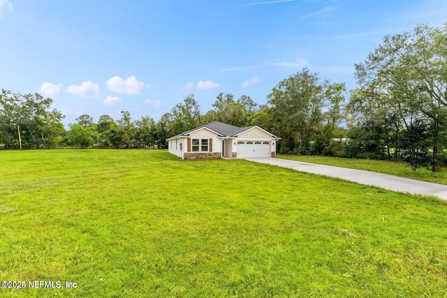 view of front of house with a garage, driveway, and a front lawn