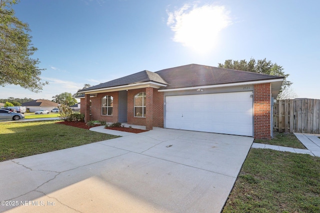 2721 Ridge Haven Dr, Green Cove Springs, FL 32043 - ranch-style home with fence, an attached garage, concrete driveway, brick siding, and a front lawn