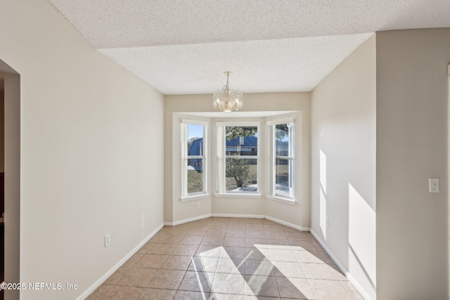 2721 Ridge Haven Dr, Green Cove Springs, FL 32043 - spare room with light tile patterned flooring, a textured ceiling, baseboards, and an inviting chandelier