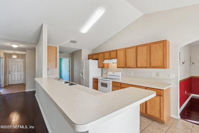 2721 Ridge Haven Dr, Green Cove Springs, FL 32043 - kitchen featuring light countertops, a sink, lofted ceiling, under cabinet range hood, and white appliances