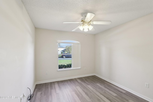 2721 Ridge Haven Dr, Green Cove Springs, FL 32043 - spare room with baseboards, a ceiling fan, wood finished floors, and a textured ceiling