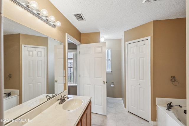 2721 Ridge Haven Dr, Green Cove Springs, FL 32043 - bathroom featuring a bath, a textured ceiling, visible vents, and vanity