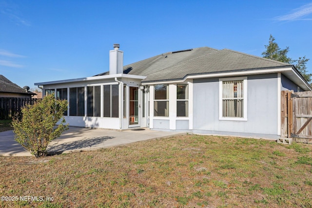 2721 Ridge Haven Dr, Green Cove Springs, FL 32043 - back of property featuring a chimney, fence, a sunroom, a patio, and a lawn