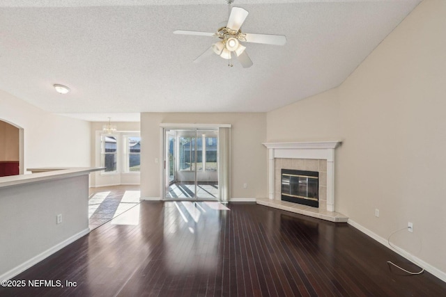 2721 Ridge Haven Dr, Green Cove Springs, FL 32043 - unfurnished living room with ceiling fan, wood finished floors, a tile fireplace, and a textured ceiling