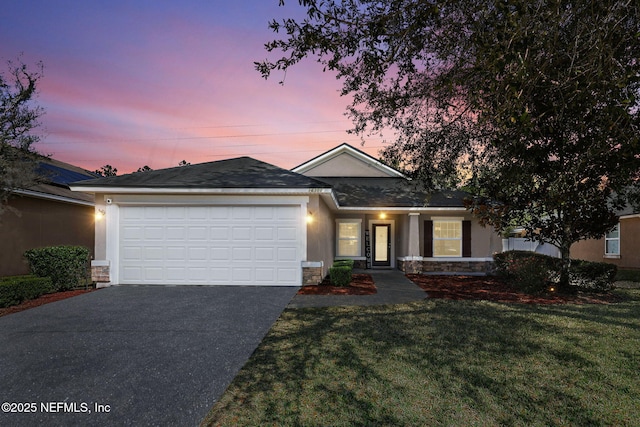 single story home featuring stucco siding, aphalt driveway, stone siding, a front yard, and a garage