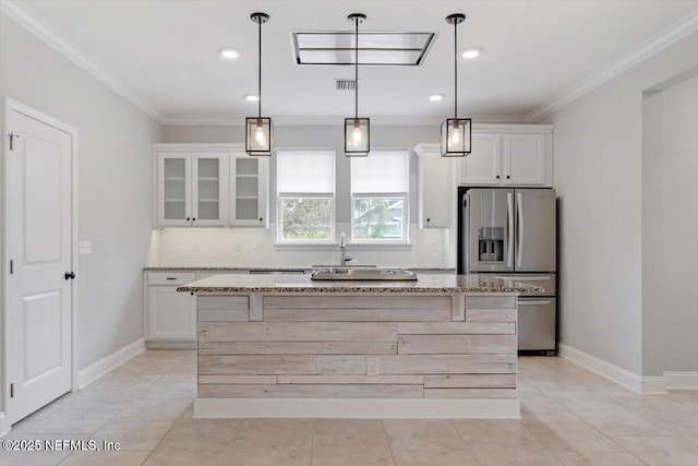 kitchen with backsplash, crown molding, light stone countertops, stainless steel refrigerator with ice dispenser, and white cabinetry