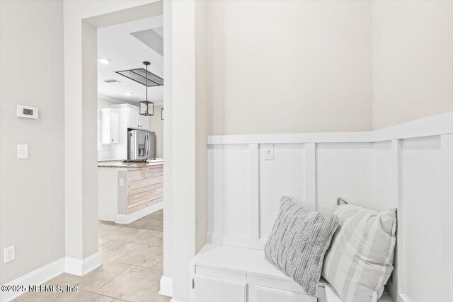 mudroom with light tile patterned floors and baseboards