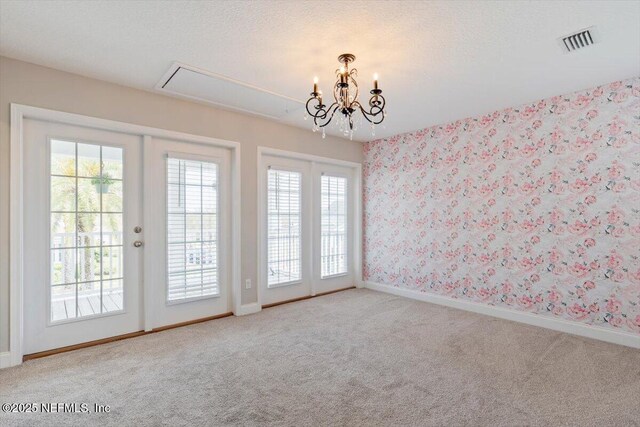 unfurnished room featuring visible vents, carpet floors, baseboards, and wallpapered walls