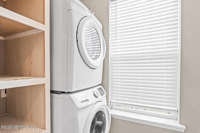 laundry area with stacked washer / dryer