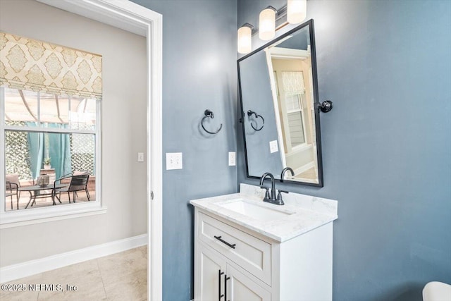 bathroom featuring tile patterned floors, baseboards, and vanity