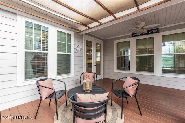 wooden terrace featuring french doors and ceiling fan