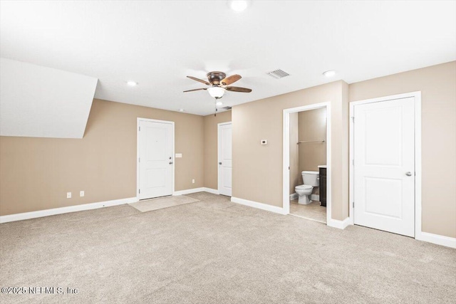 interior space with visible vents, light carpet, baseboards, and a ceiling fan