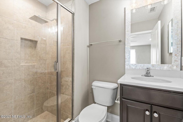 full bathroom featuring visible vents, toilet, a textured ceiling, a shower stall, and vanity