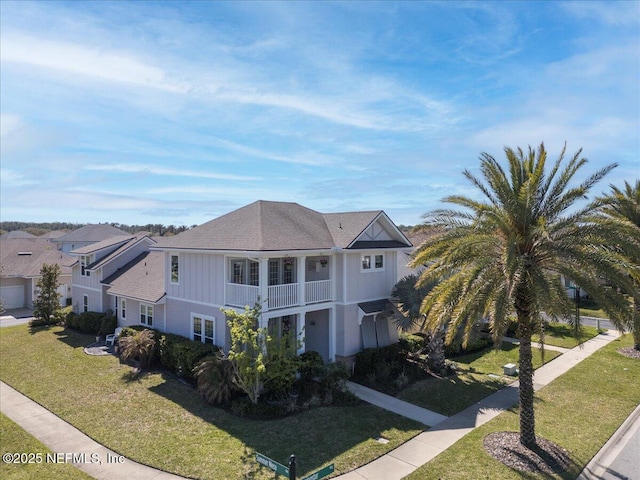 view of front of house featuring a front yard and a balcony