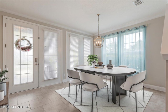 dining space featuring visible vents, baseboards, a chandelier, and crown molding