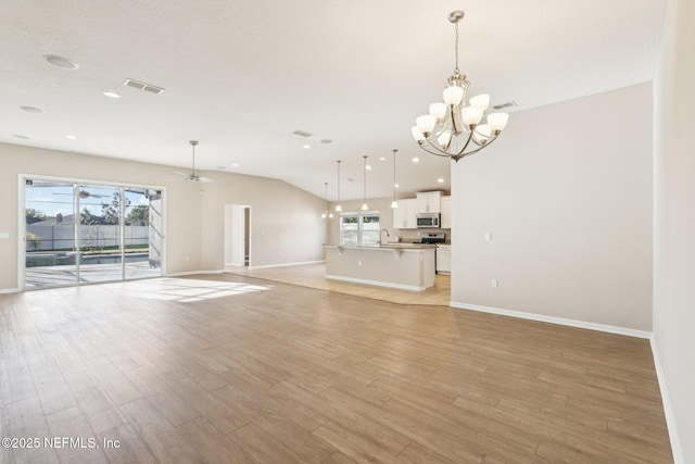 unfurnished living room with visible vents, baseboards, vaulted ceiling, recessed lighting, and light wood-style floors