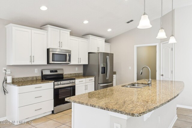 kitchen with a center island with sink, visible vents, a sink, stainless steel appliances, and white cabinets