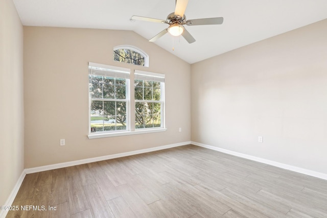 unfurnished room with vaulted ceiling, ceiling fan, baseboards, and wood finished floors