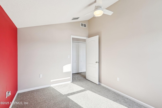 unfurnished bedroom featuring baseboards, visible vents, carpet floors, and ceiling fan