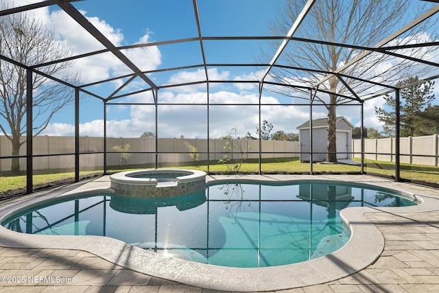 view of pool featuring glass enclosure, a pool with connected hot tub, a fenced backyard, and an outdoor structure