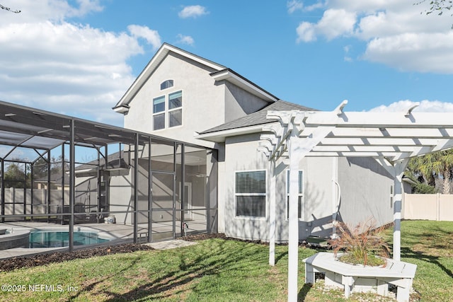 back of property featuring stucco siding, a pergola, fence, a yard, and glass enclosure