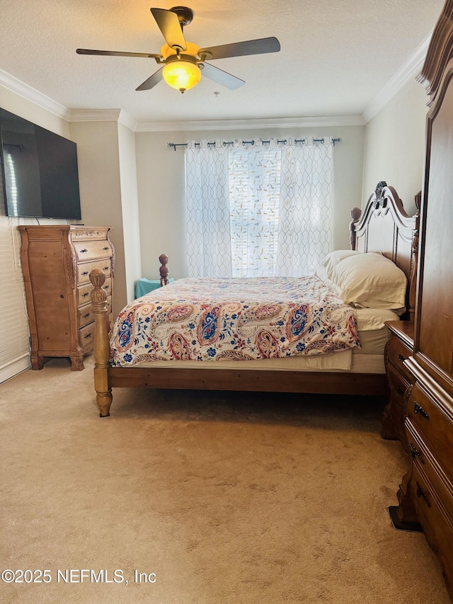 bedroom with light carpet, a ceiling fan, crown molding, and a textured ceiling