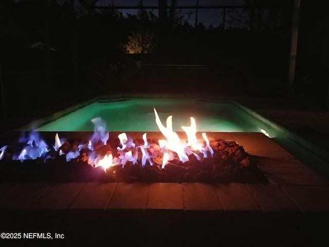 pool at twilight featuring an outdoor pool