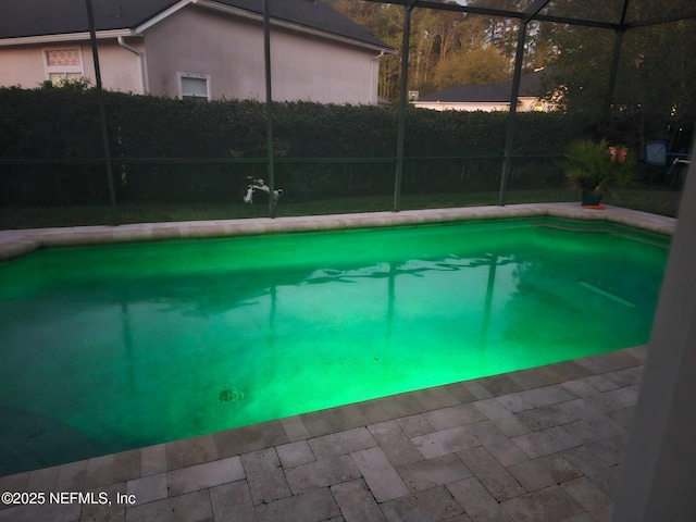 outdoor pool featuring glass enclosure