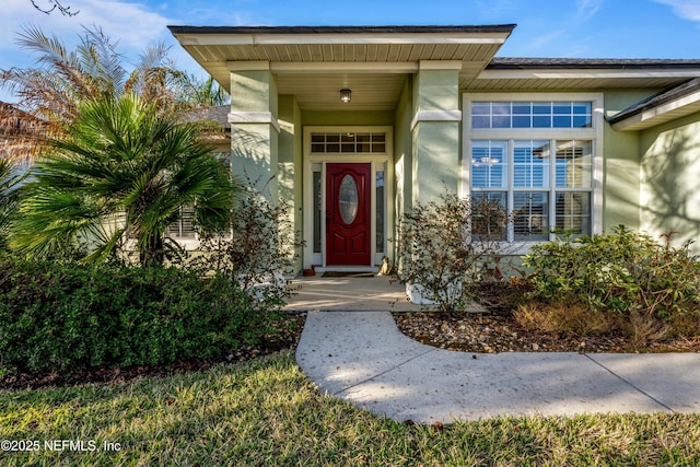 entrance to property featuring stucco siding