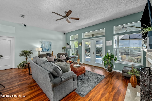 living room featuring wood finished floors, a ceiling fan, french doors, and a textured ceiling