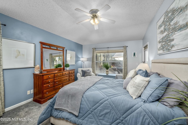 bedroom with a ceiling fan, carpet, baseboards, and a textured ceiling