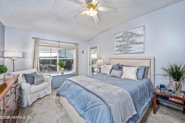 bedroom featuring multiple windows, carpet floors, a textured ceiling, and lofted ceiling