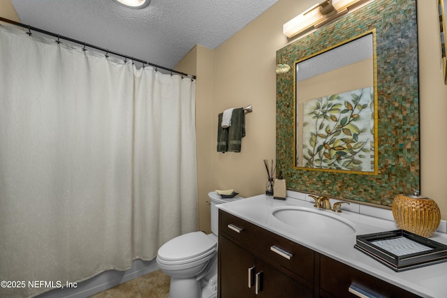 bathroom with vanity, toilet, tile patterned flooring, and a textured ceiling